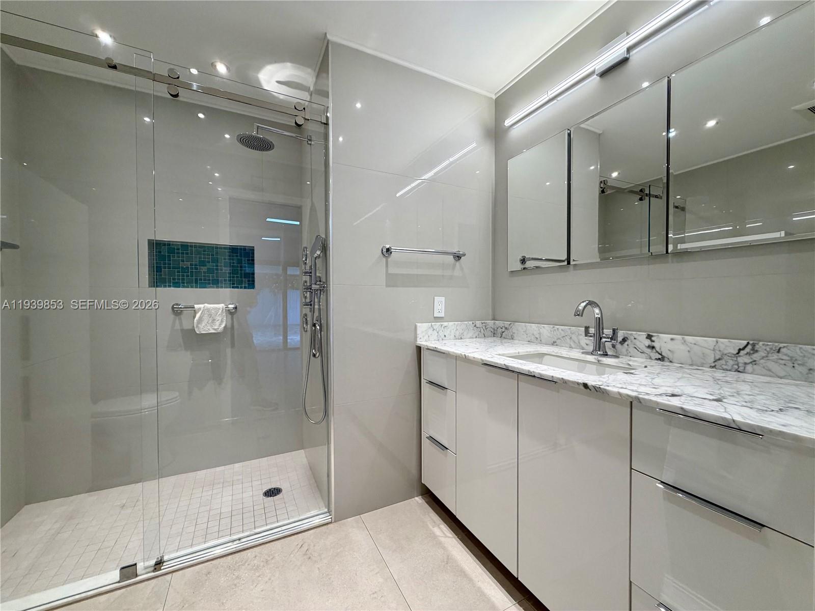 9064 Southwest 6th Street, Unit 9064 Miami, FL 33174 - Photo 16 of 20 a bathroom with a shower sink and mirror