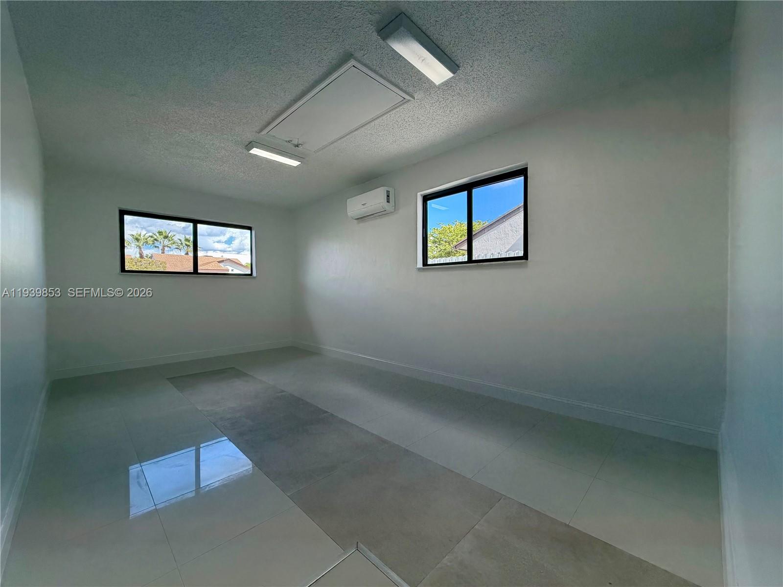 9064 Southwest 6th Street, Unit 9064 Miami, FL 33174 - Photo 17 of 20 an empty room with windows