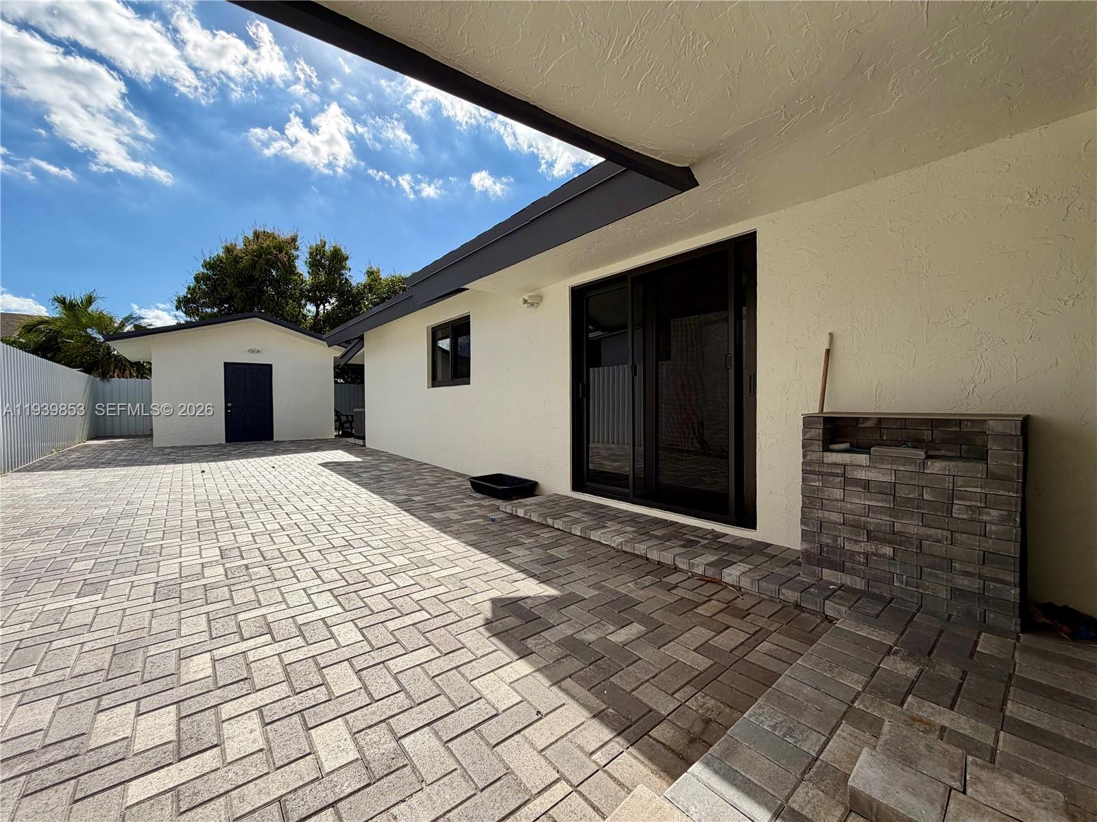 9064 Southwest 6th Street, Unit 9064 Miami, FL 33174 - Photo 18 of 20 a front view of a house with a yard