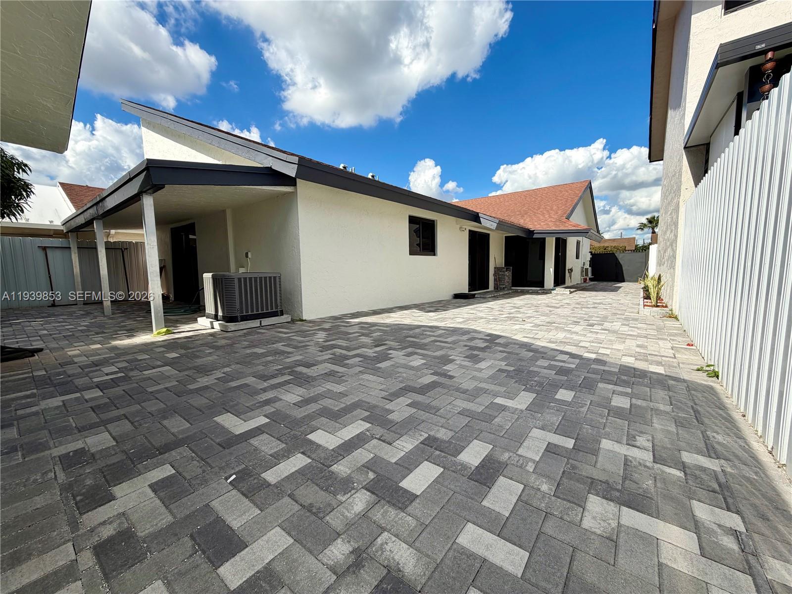 9064 Southwest 6th Street, Unit 9064 Miami, FL 33174 - Photo 19 of 20 a front view of a house with a yard