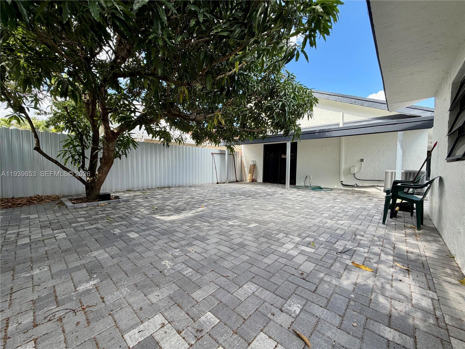 9064 Southwest 6th Street, Unit 9064 Miami, FL 33174 - Photo 20 of 20 a view of a house with backyard and a tree