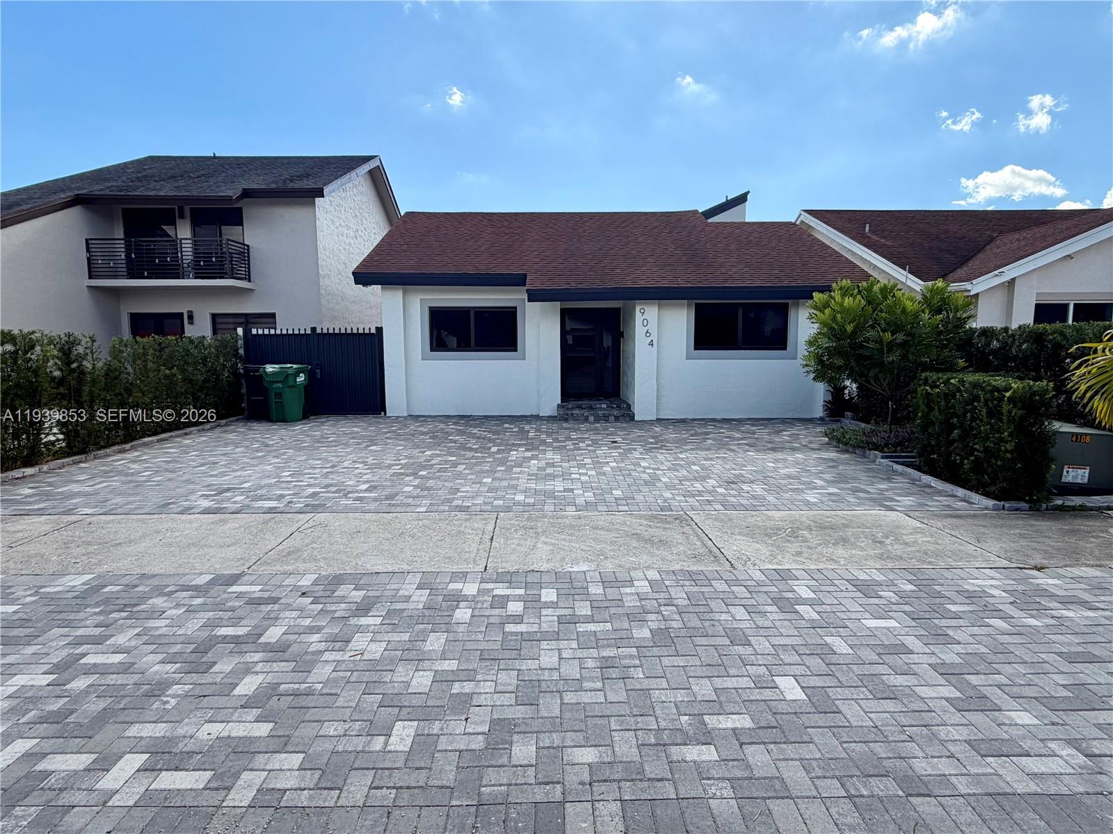 9064 Southwest 6th Street, Unit 9064 Miami, FL 33174 - Photo 2 of 20 a front view of a house with a yard