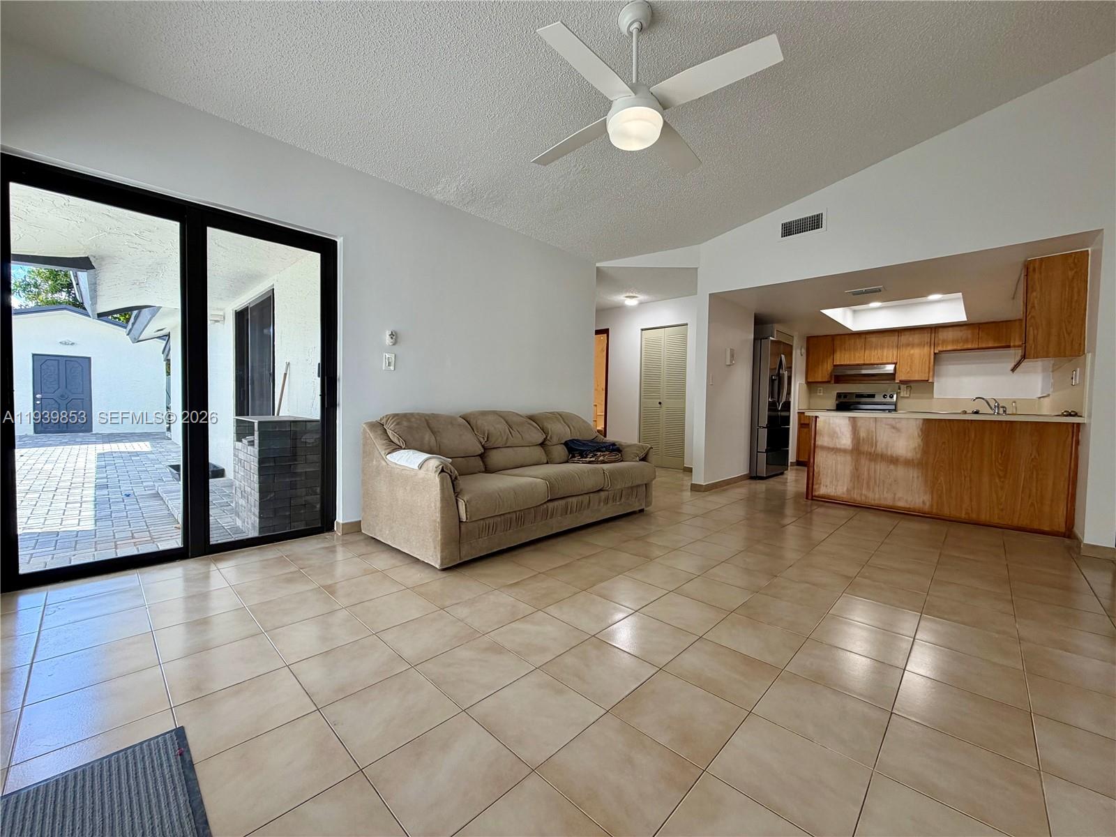 9064 Southwest 6th Street, Unit 9064 Miami, FL 33174 - Photo 5 of 20 a living room with furniture and a large window