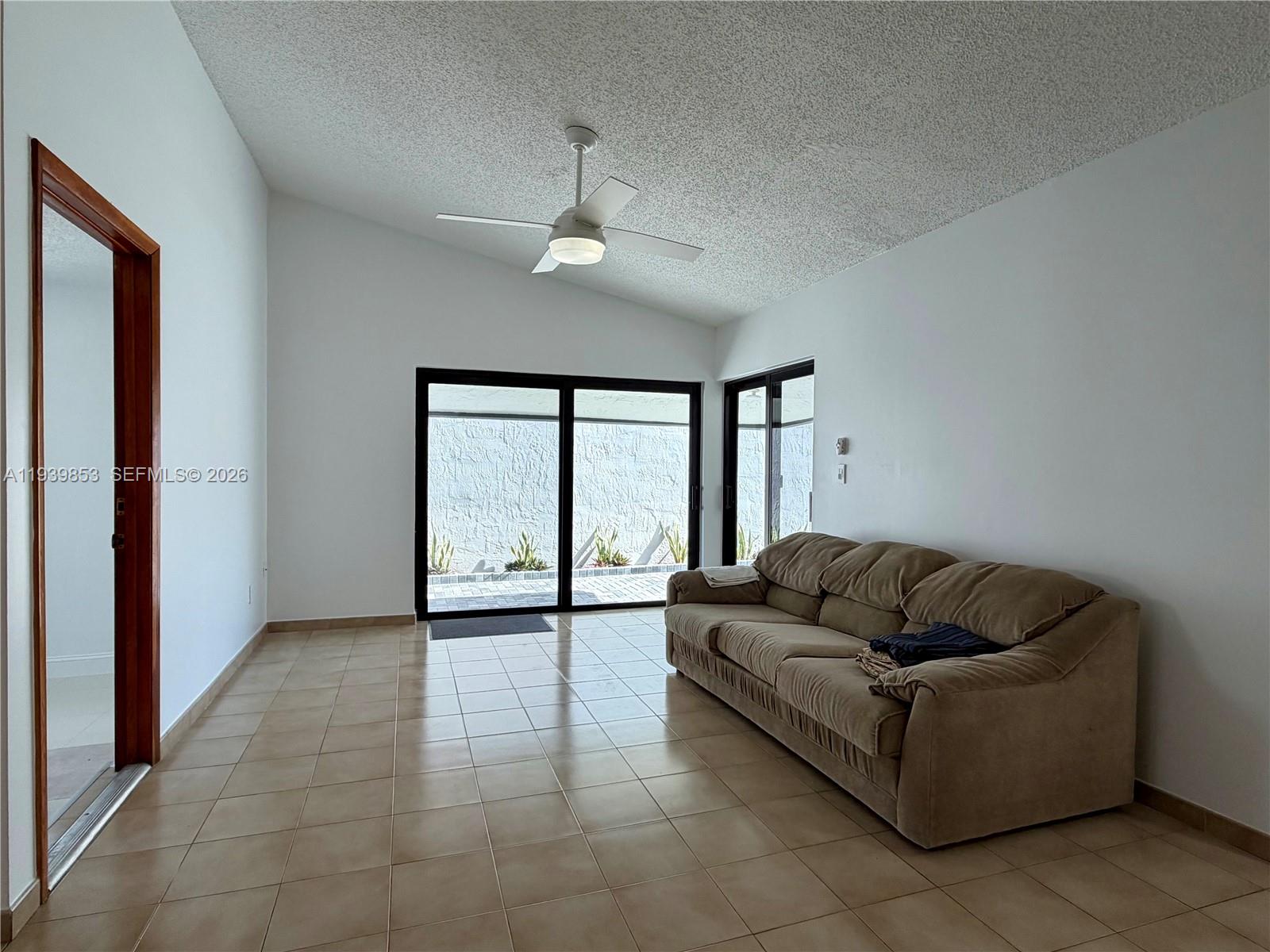 9064 Southwest 6th Street, Unit 9064 Miami, FL 33174 - Photo 6 of 20 a living room with furniture and a large window