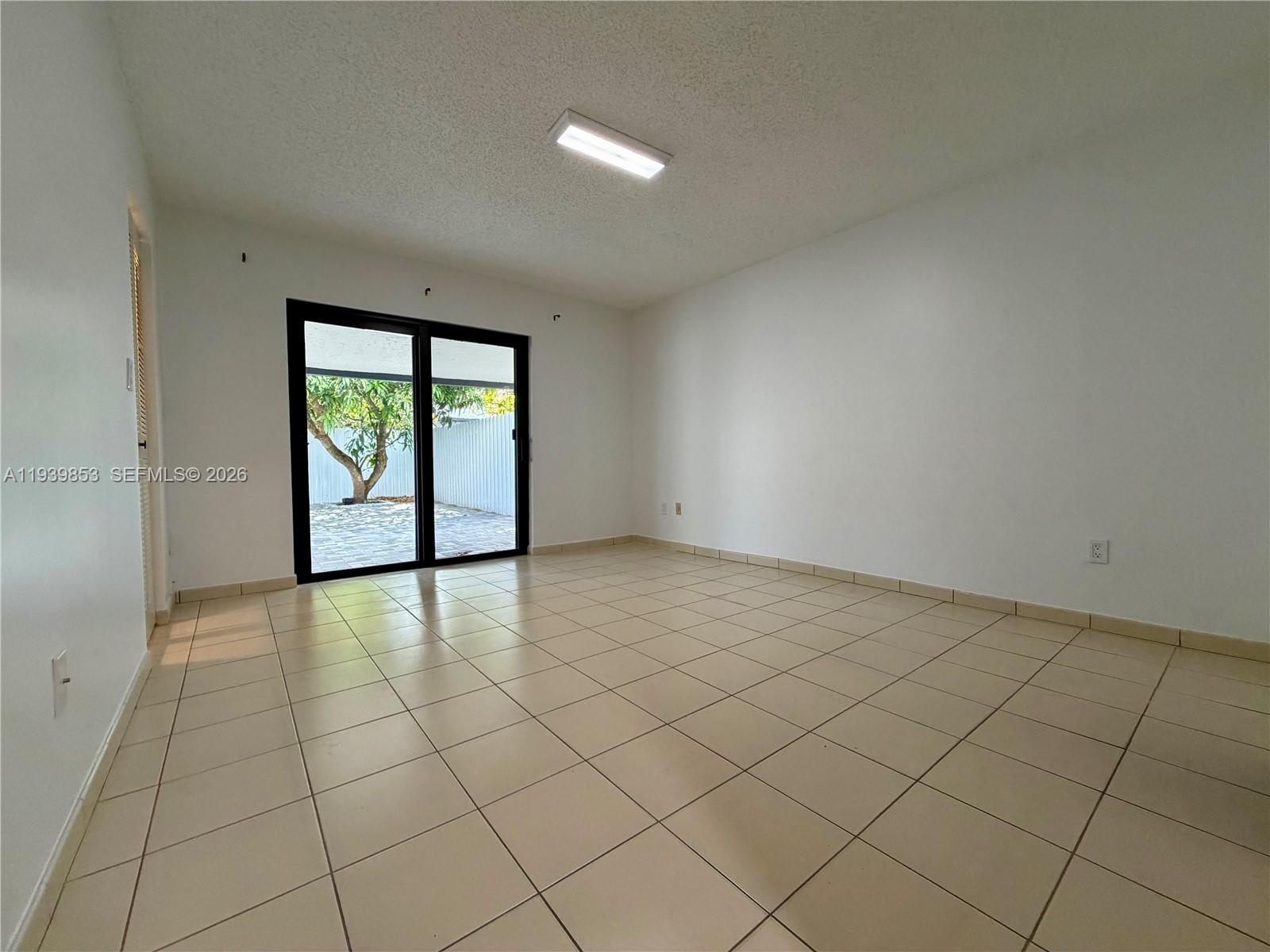 9064 Southwest 6th Street, Unit 9064 Miami, FL 33174 - Photo 10 of 20 an empty room with windows