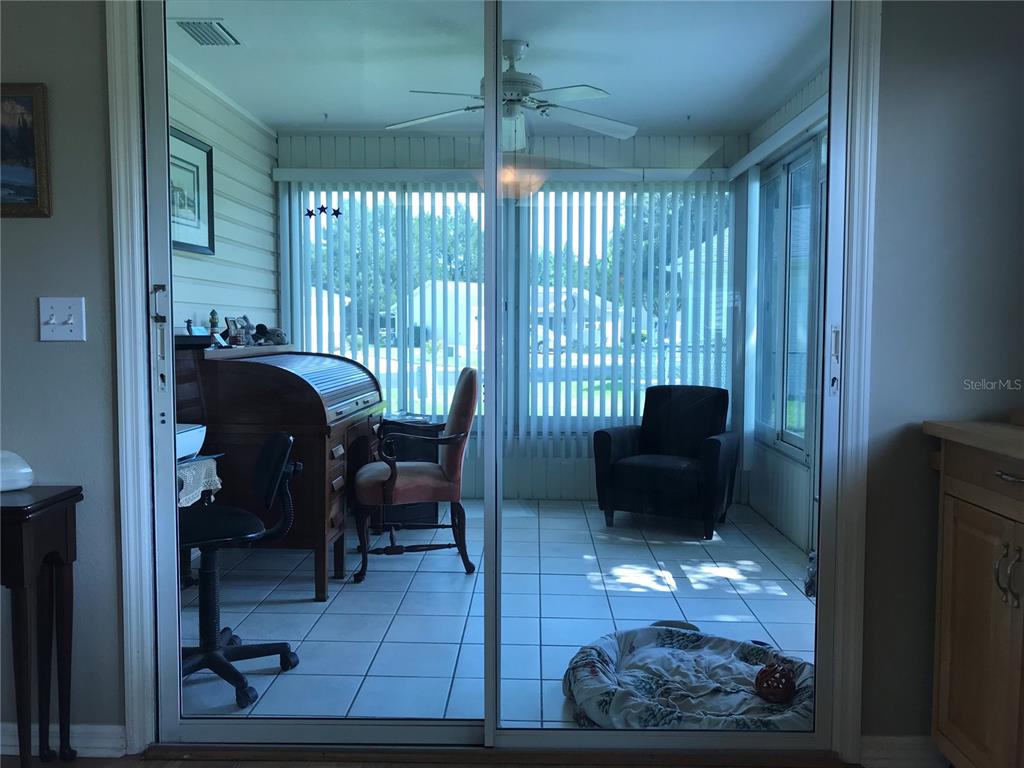 11879 Southwest 137th Loop Dunnellon, FL 34432 - Photo 26 of 37 a living room with furniture and a floor to ceiling window