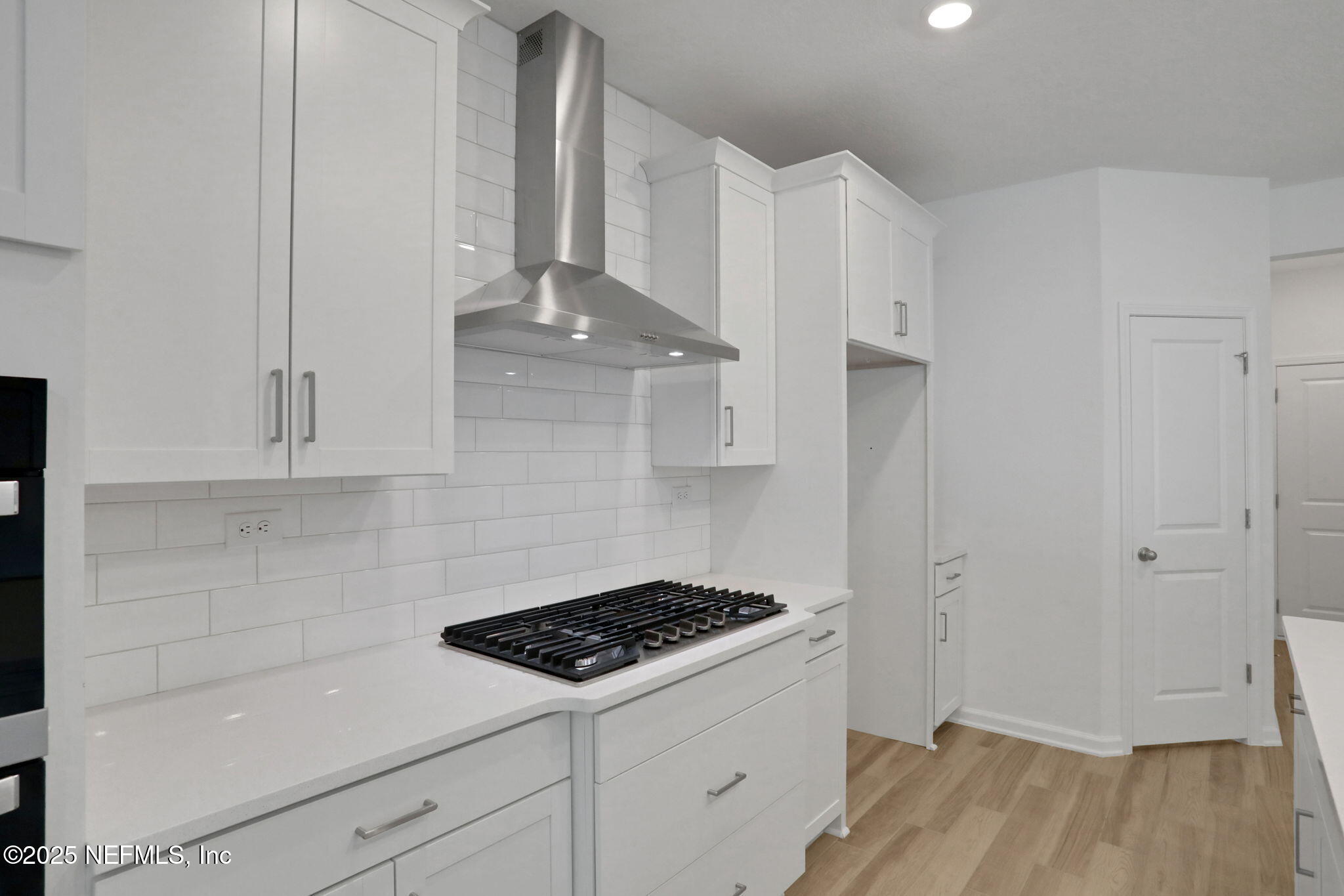 317 Archstone Way St. Augustine, FL 32092 - Photo 30 of 46 a kitchen with granite countertop white cabinets and white appliances