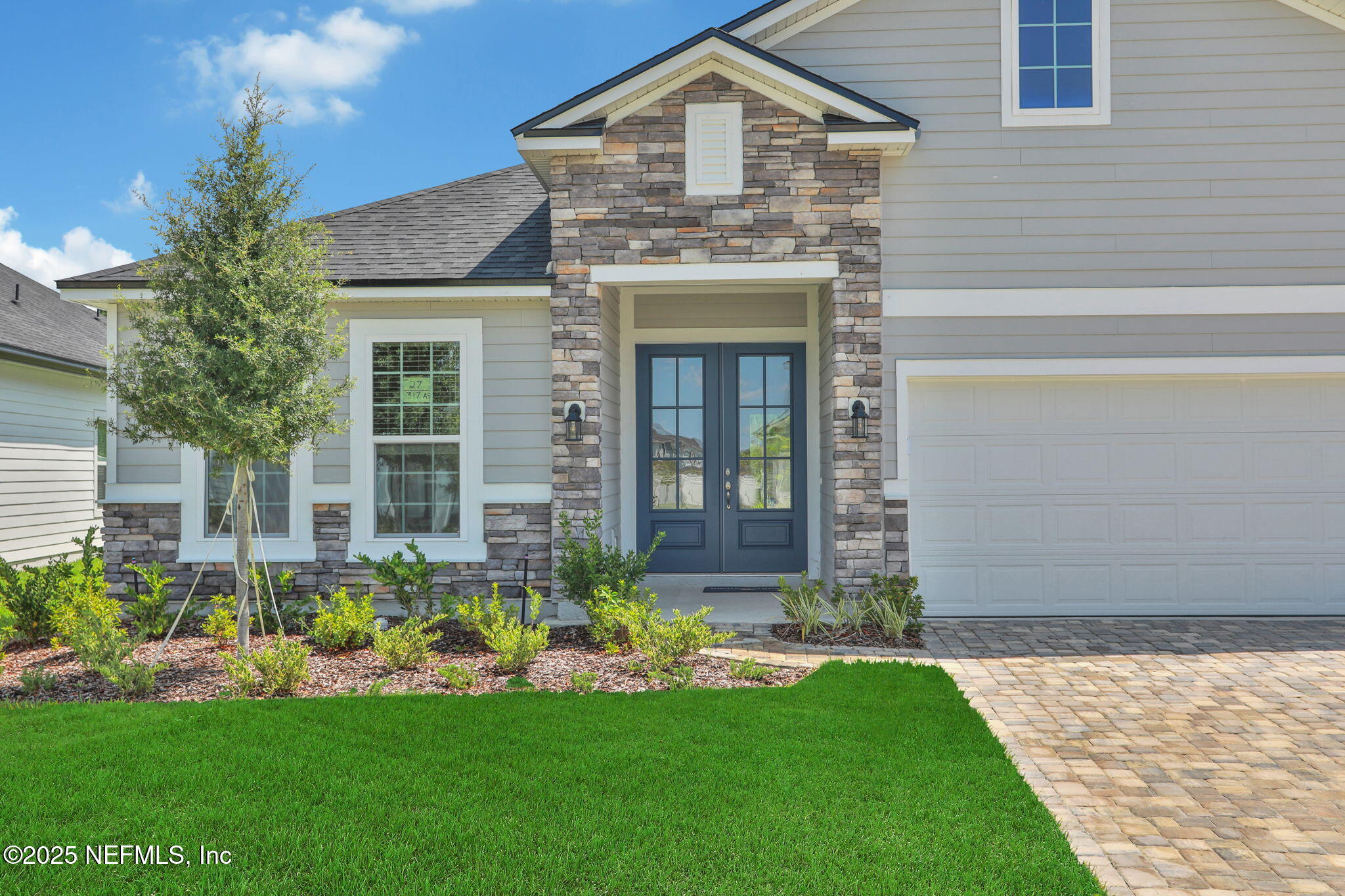 317 Archstone Way St. Augustine, FL 32092 - Photo 3 of 46 a front view of a house with a garden and plants