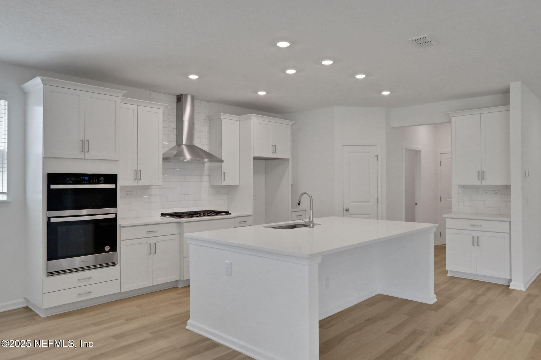 317 Archstone Way St. Augustine, FL 32092 - Photo 32 of 46 a kitchen with a sink stainless steel appliances and white cabinets