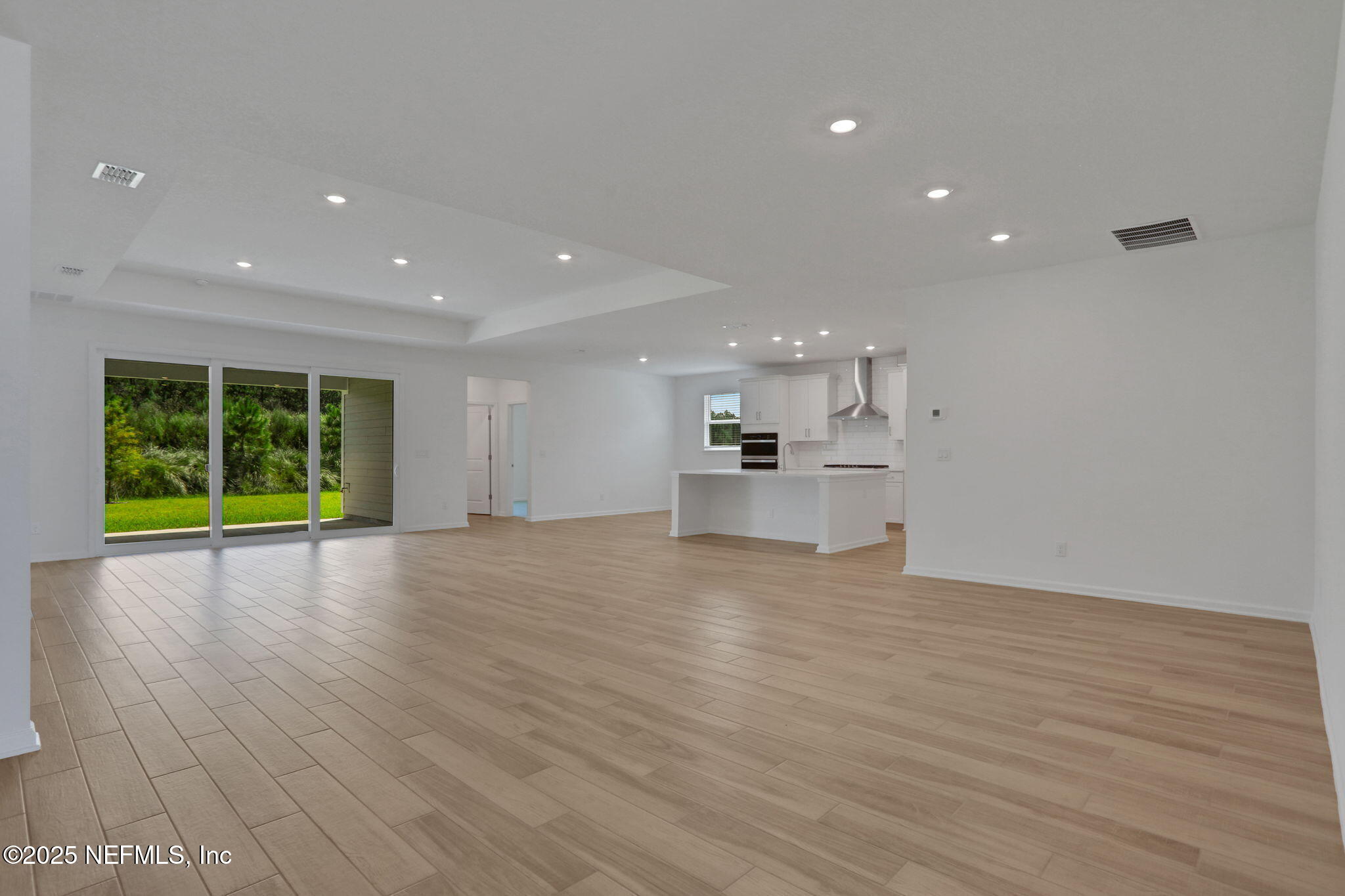 317 Archstone Way St. Augustine, FL 32092 - Photo 40 of 46 a view of empty room with wooden floor and windows