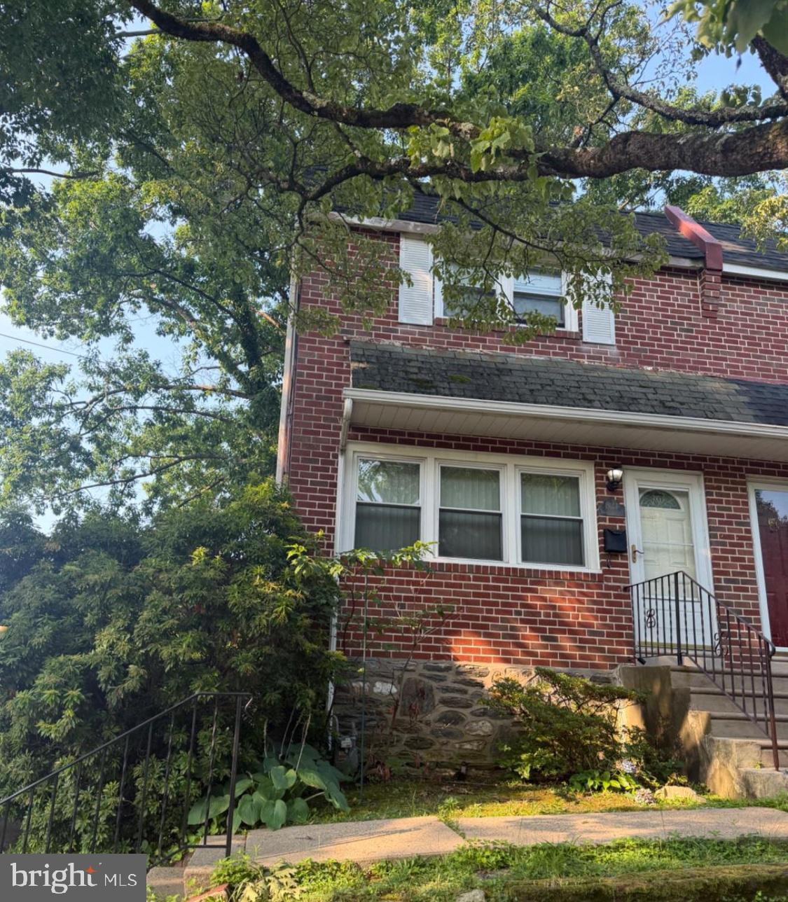 821 Beech Road Wallingford, PA 19086 - Photo 1 of 1 Charming brick home with lush greenery.