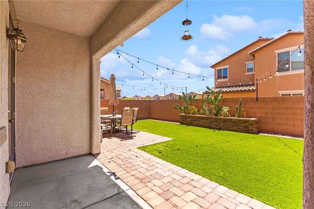 6435 Point Isabel Way Las Vegas, NV 89122 - Photo 43 of 57 A private outdoor space with a charming patio and low-maintenance turf for serene desert living.