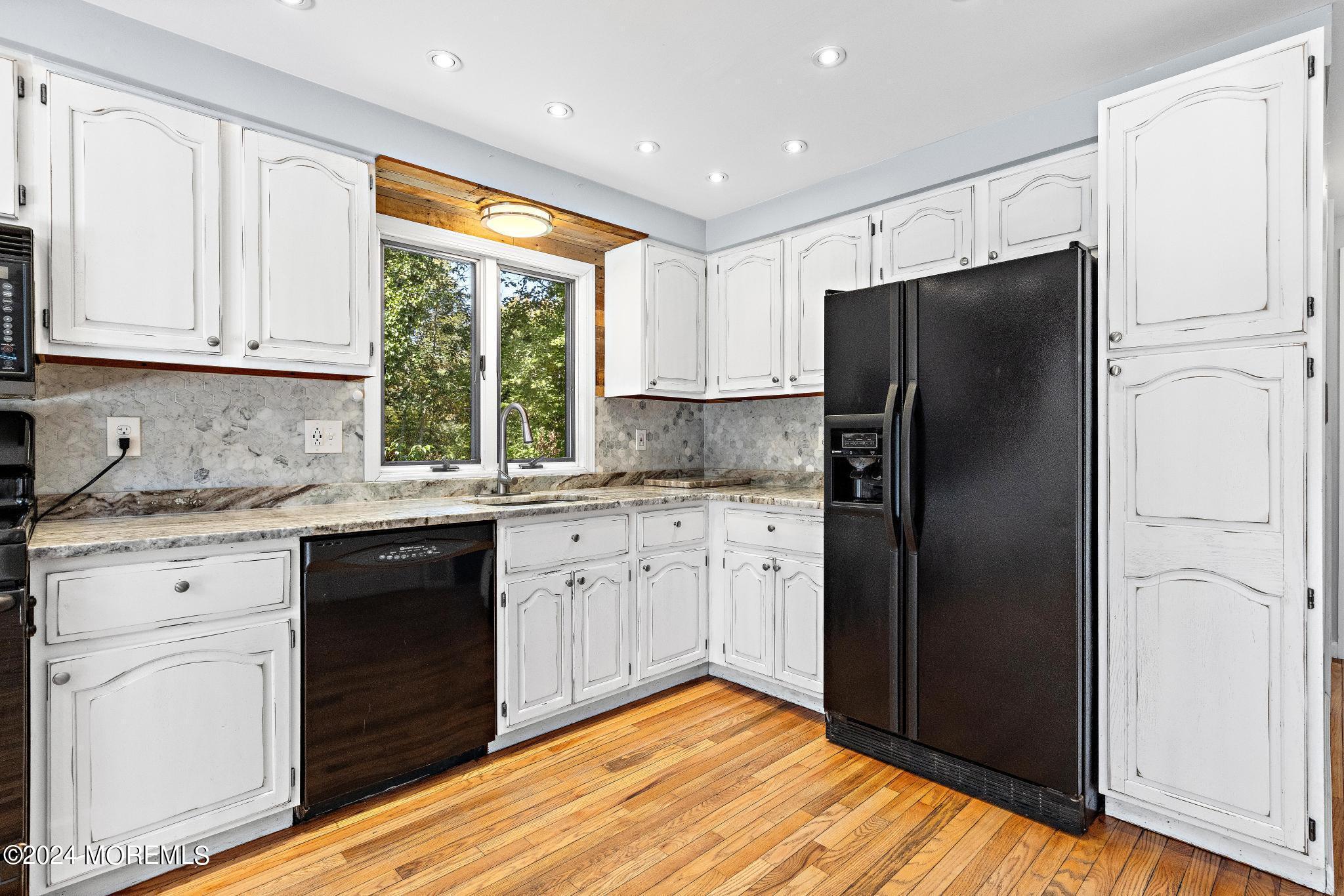 32 Barnegat Beach Drive Waretown, NJ 08758 - Photo 17 of 49 a kitchen with granite countertop stainless steel appliances a refrigerator cabinets and a window