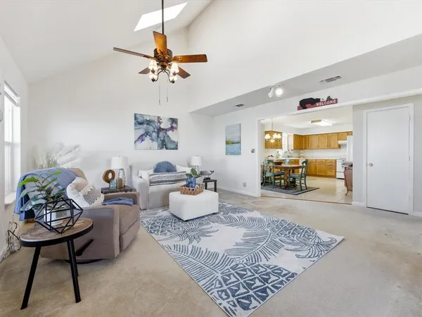 a view of a dining room with furniture and chandelier