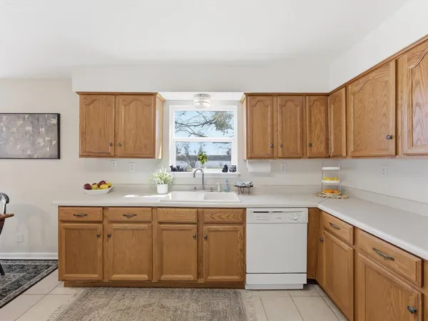 a living room with lots of furniture a chandelier fan and a dining table