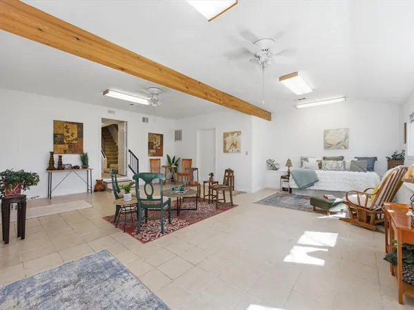 a bedroom with a bed a table and chair