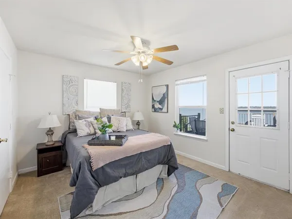a roof deck with table and chairs with wooden floor