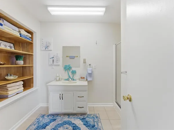 a bedroom with a bed a couch and a window