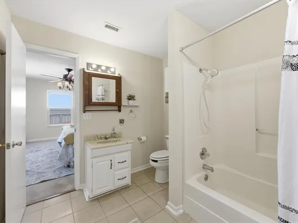 a bathroom with a sink mirror vanity and toilet