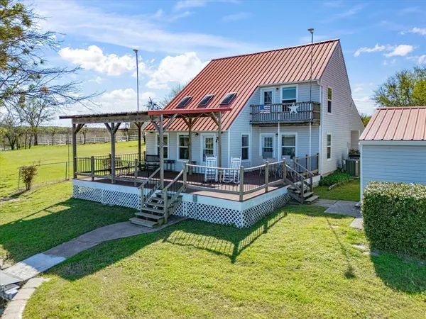a view of a swimming pool with lawn chairs under an umbrella