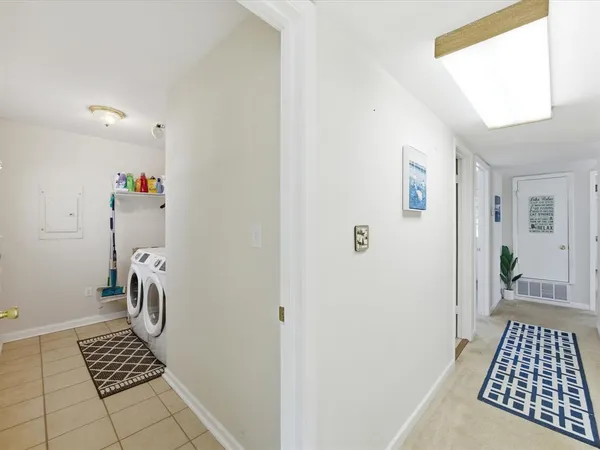 a view of a balcony with chairs and wooden floor
