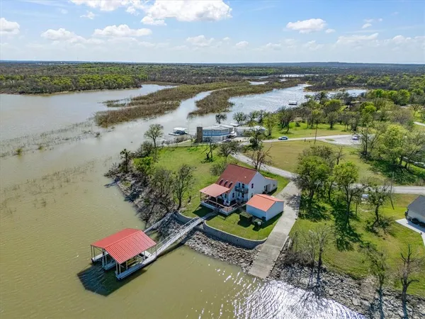 an aerial view of a house with a lake view