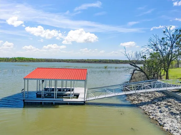 a view of a house with swimming pool and a yard