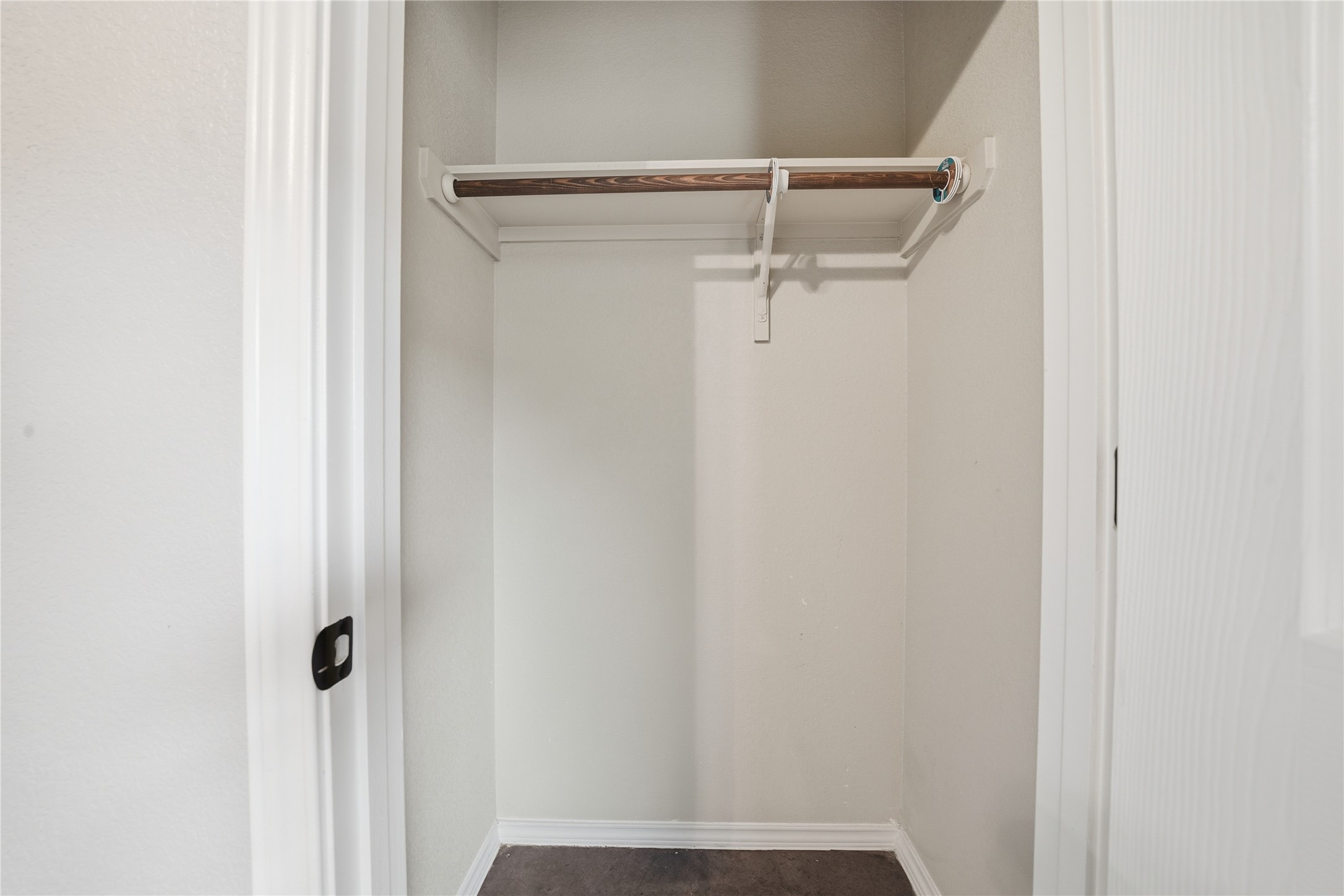 533 Jack Rabbit Lane, Unit A Buda, TX 78610 - Photo 28 of 34 Functional closet featuring a convenient built-in rod and shelf for organized storage.