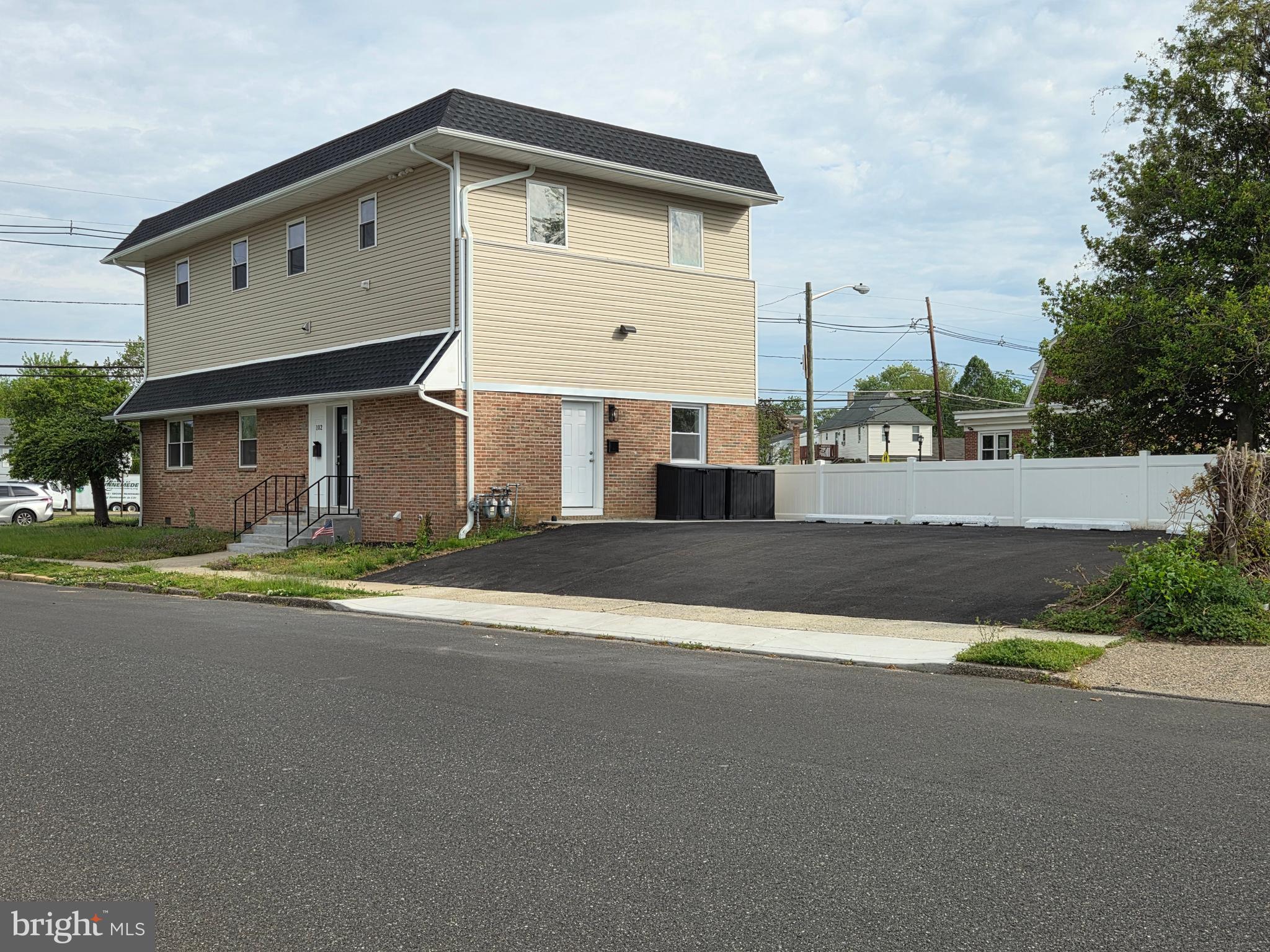 102 East Clements Bridge Road, Unit 2 Runnemede, NJ 08078 - Photo 3 of 18 a front view of a house with a yard and garage