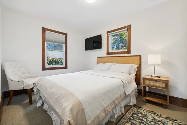 a bedroom with bed and a window