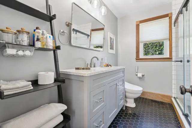 a bathroom with a toilet sink and mirror