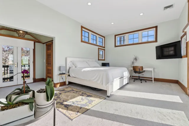 a view of a backyard with plants and ocean view