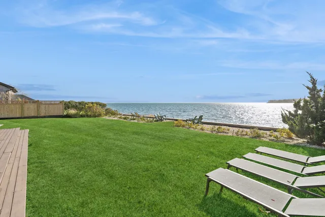 a front view of a house with a garden and yard