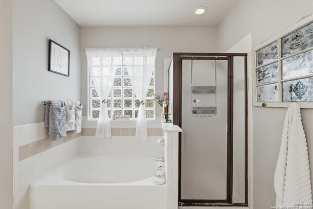 a white bath tub sitting next to a window