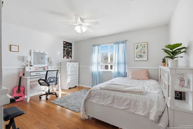 a bedroom with a bed gym equipment and view of living room