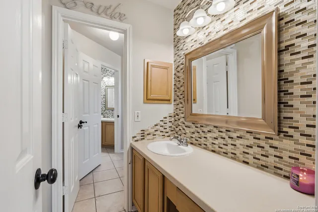 a bathroom with a sink and a mirror