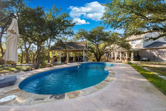 a view of a swimming pool with sitting area