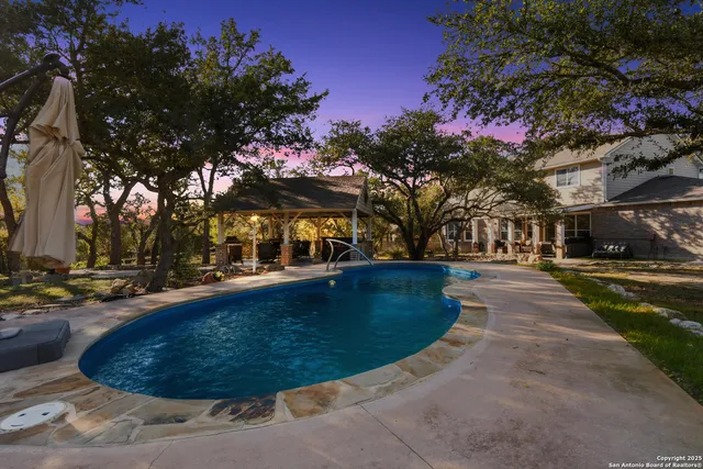 a view of a swimming pool with sitting area