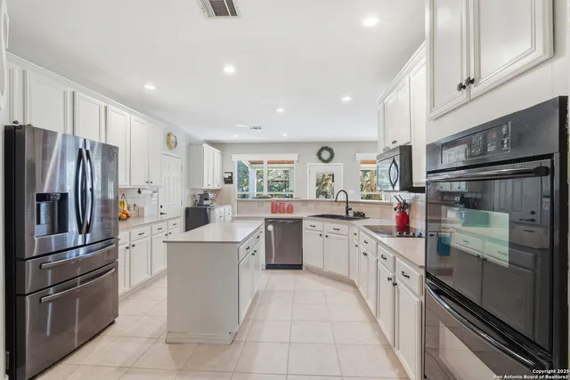 a kitchen with cabinets and stainless steel appliances