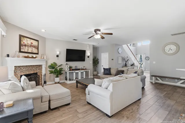 a living room with furniture fireplace and a flat screen tv
