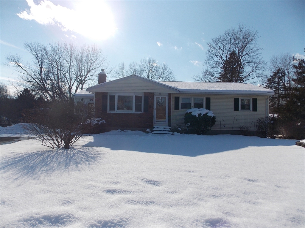 26 Old Bolton Road Hudson, MA 01749 - Photo 1 of 19 a front view of a house with a yard and garage