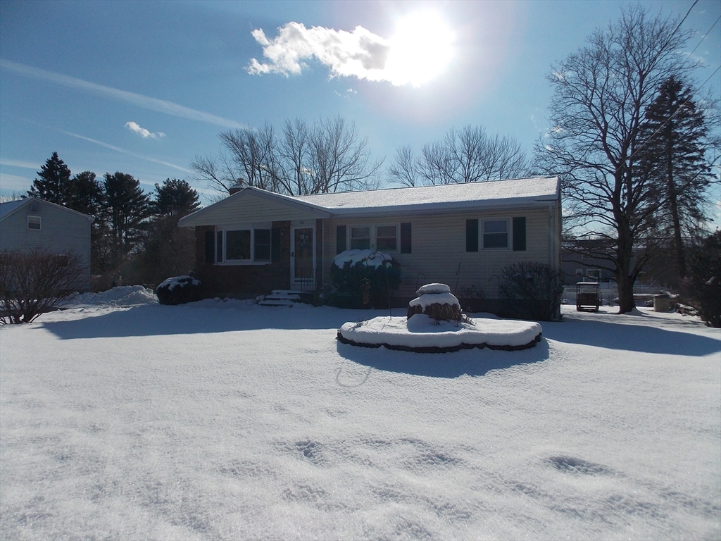 26 Old Bolton Road Hudson, MA 01749 - Photo 2 of 19 a front view of a house with a yard and garage