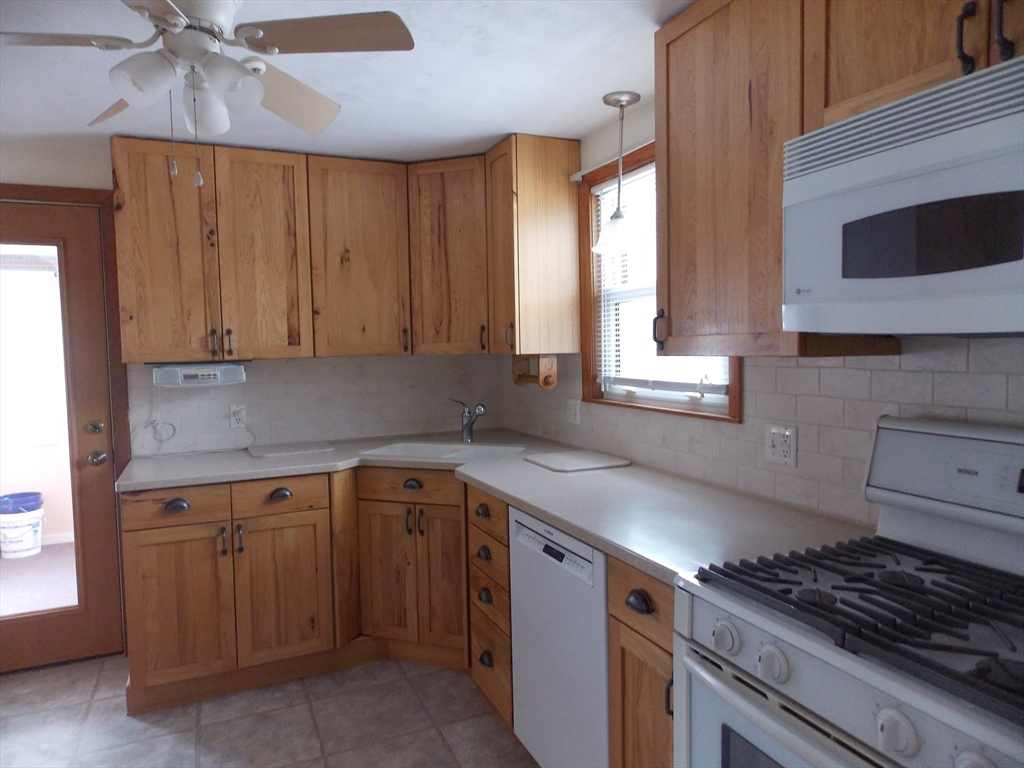 26 Old Bolton Road Hudson, MA 01749 - Photo 4 of 19 a kitchen with cabinets appliances and a window