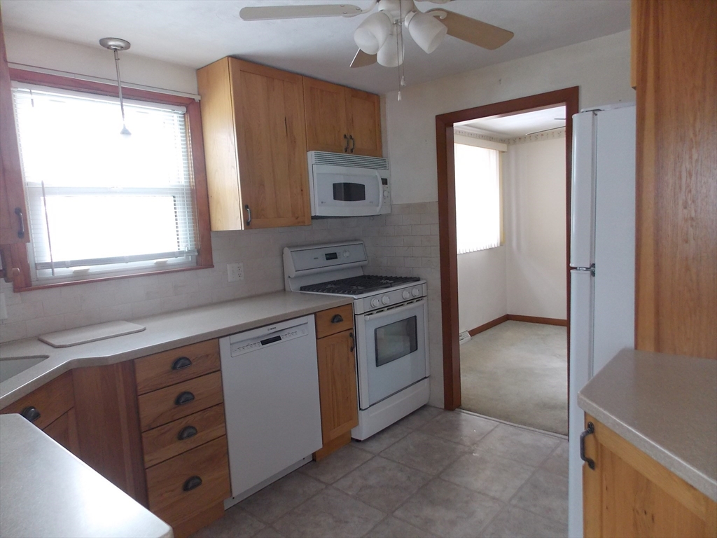 26 Old Bolton Road Hudson, MA 01749 - Photo 5 of 19 a kitchen with white cabinets and white appliances