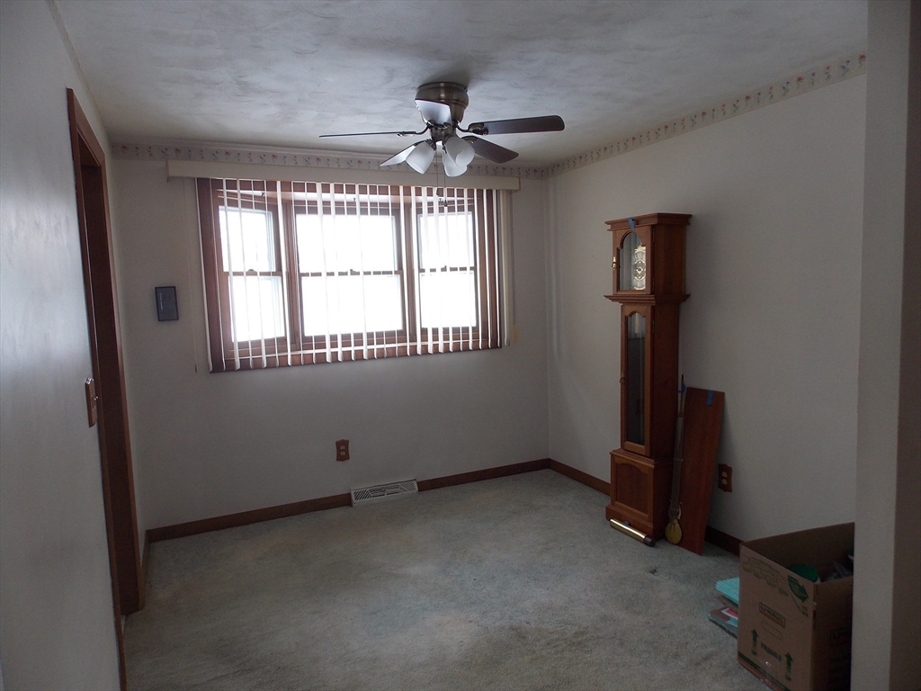 26 Old Bolton Road Hudson, MA 01749 - Photo 6 of 19 an empty room with windows and fan