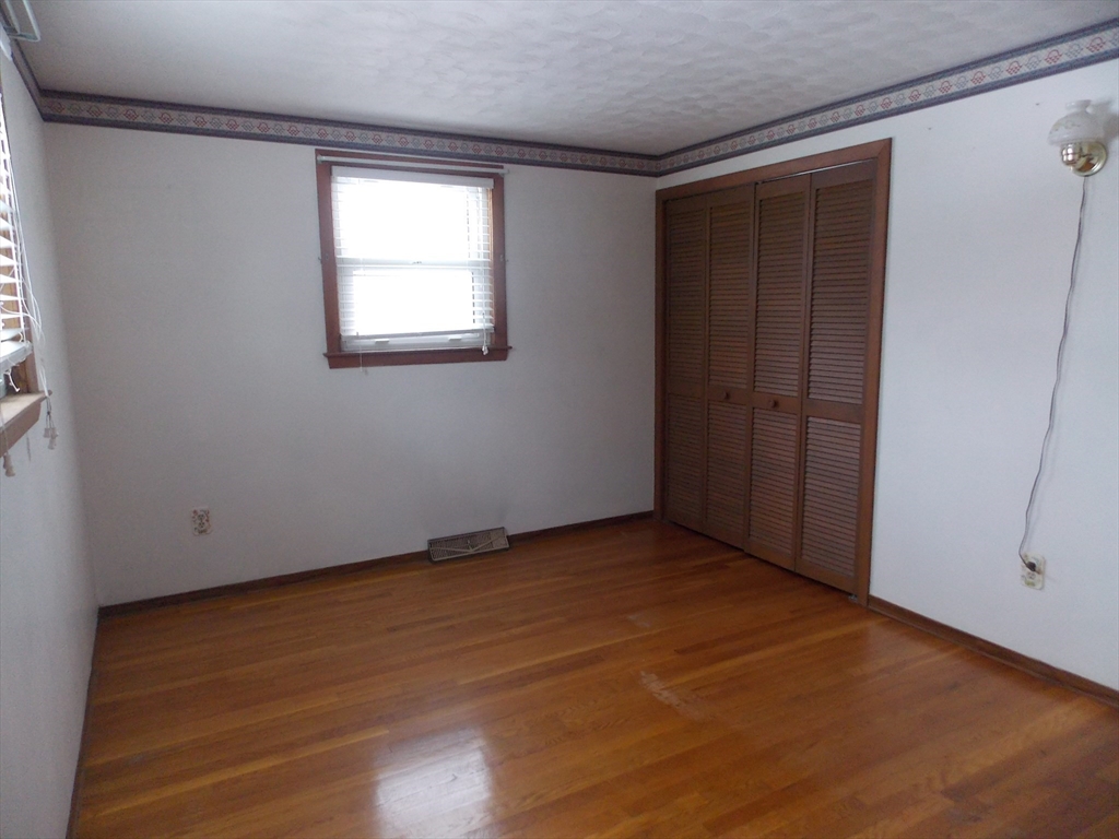26 Old Bolton Road Hudson, MA 01749 - Photo 9 of 19 an empty room with wooden floor and windows