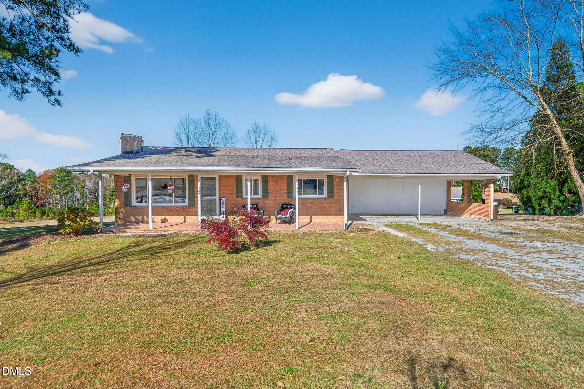 a view of a house with a yard and sitting area