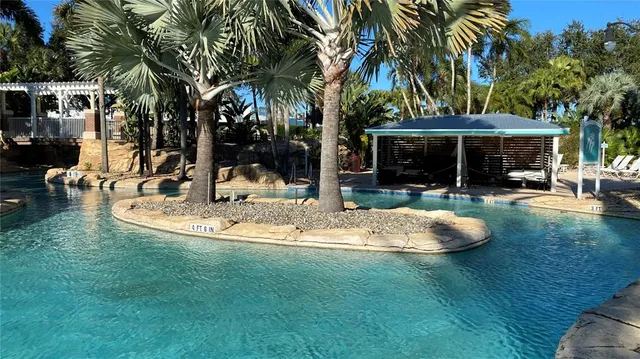 a view of a house with swimming pool and sitting area