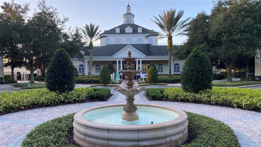 365 Muirfield Loop Reunion, FL 34747 - Photo 23 of 24 a front view of a house with a yard garage and fountain