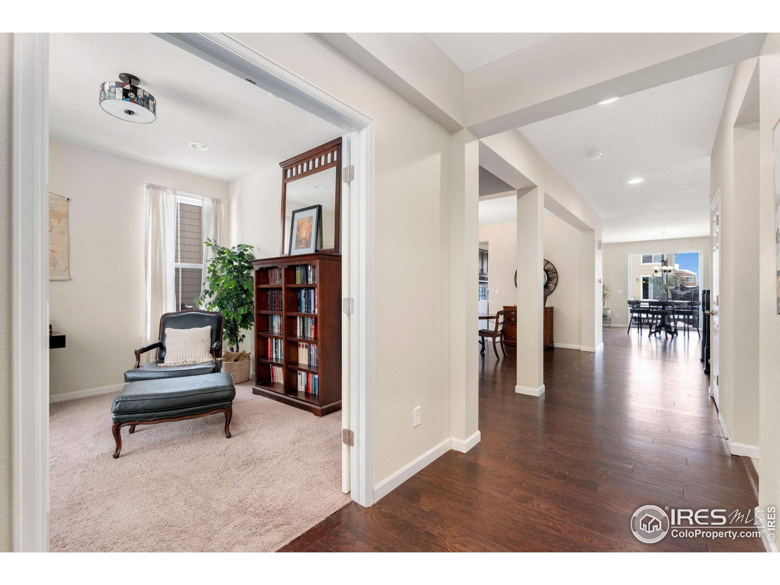 6770 Spring Rain Road Timnath, CO 80547 - Photo 1 of 30 a living room with furniture and wooden floor